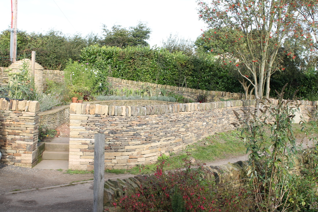 curving stone walled garden