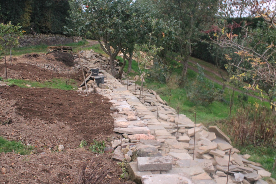 back filling soil to a dry stone terrace